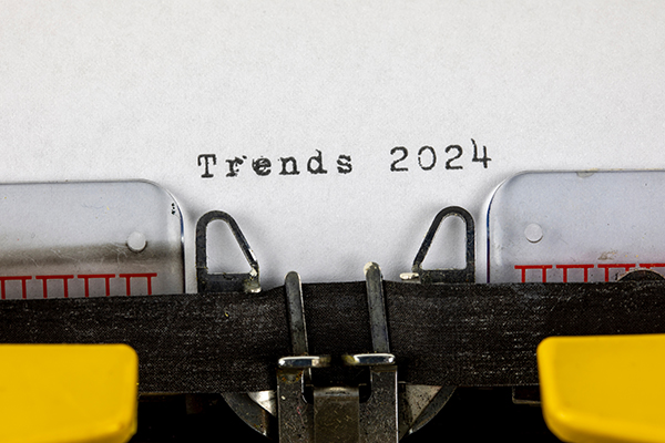 Publishing and Writing Trends of 2024-Blog A close up of paper in an old typewriter that reads "Trends 2024"