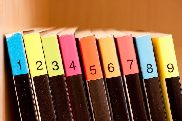 Open book on the table in a library and bookshelf