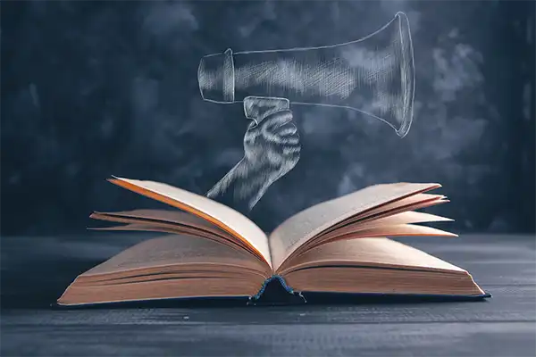 How a Publisher’s Package Takes the Guesswork Out of Promotion An opened book with a chalk drawn hand holding a loudspeaker sticking out of the book